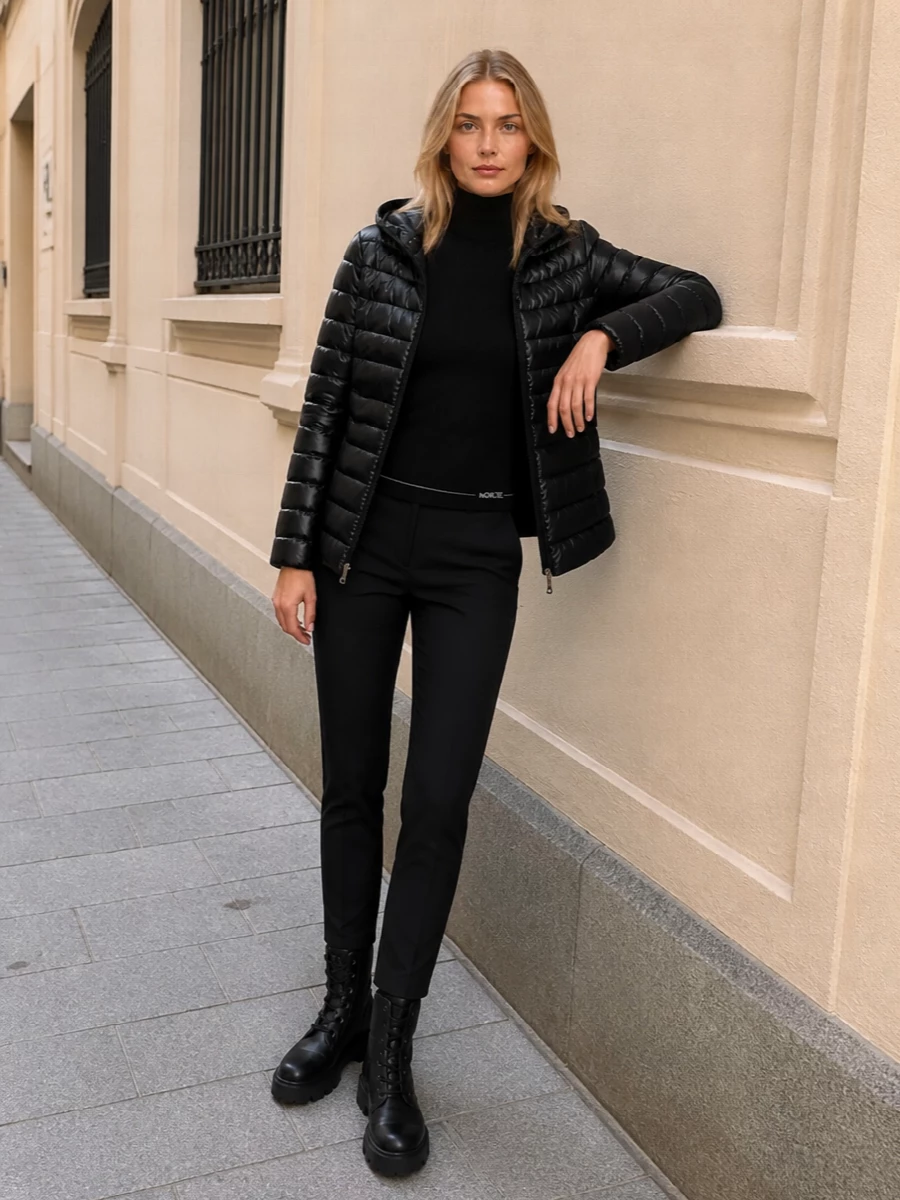 I am keeping this as a clean Moncler-driven city-uniform, so I chose the top and trouser route rather than a dress, which would fight the puffer’s sporty, technical energy. The ribbed turtleneck and slim black trousers create a long, uninterrupted column under the glossy jacket, with quilted ankle boots and a structured tote reinforcing an all-black, quietly luxurious winter silhouette. It feels ready for cold commutes, travel days, or low-key dinners without ever tipping into performance gear or overt streetwear.