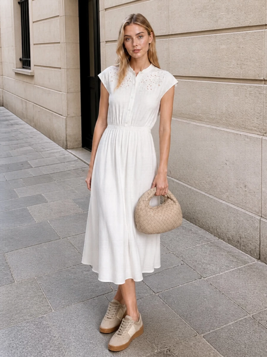 A soft-white Valentino shirt dress with delicate embroidery and a fluid midi skirt pairs effortlessly with the taupe suede sneakers for an elevated, off-duty SS look that feels polished yet relaxed. The warm-cream intrecciato mini hobo echoes the shoe’s texture and keeps the palette tonal, delivering a cohesive, quietly luxurious outfit for sunlit city days or refined casual lunches.
