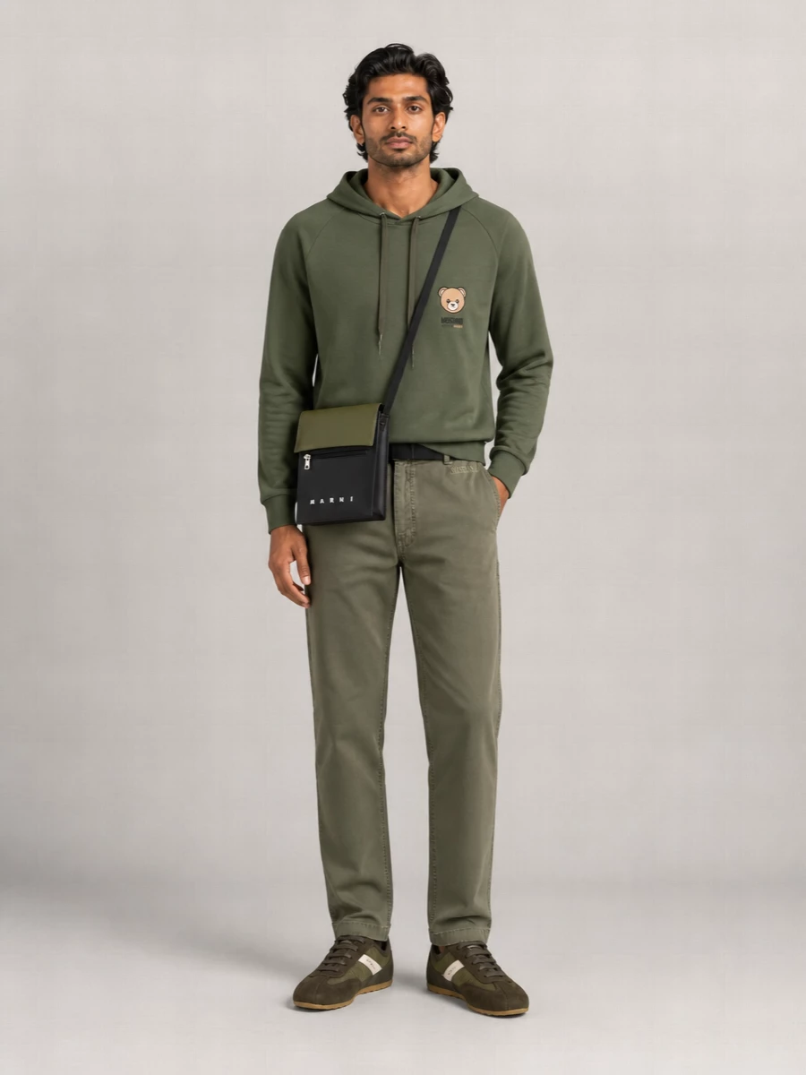 Olive-on-olive Moschino layers create a calm, tonal base that feels relaxed but intentional. Earthy Alexander McQueen sneakers and a compact Marni crossbody keep it grounded in the city, with the Y-3 belt adding a quiet technical edge. The result is an easy off-duty uniform that leans sporty without ever looking gym-bound.
