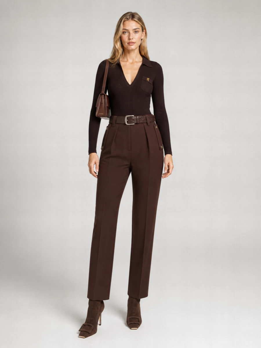 A deep chocolate column of tailoring lets the ribbed bodysuit read as a second-skin knit rather than a basic layer, all in one restrained, tonal palette. The high-waisted trouser, sculpted boots and slim shoulder bag keep the line long and uninterrupted, so the interest lives in texture and hardware instead of contrast. It is quietly sensual, city-evening dressing that feels confident rather than showy.