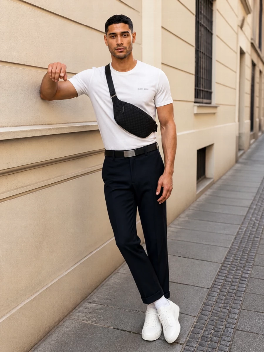 Cropped ink-black trousers meet an off white Golden Goose tee for a clean, monochrome base that feels relaxed but still precise. Pure white low-top sneakers keep the line light around the cuffed hem, while the slim black belt and compact Gucci sling bag add just enough structure and polish. It is an easy city uniform with a tailored street edge that moves from daytime errands to low-key dinners without a change.