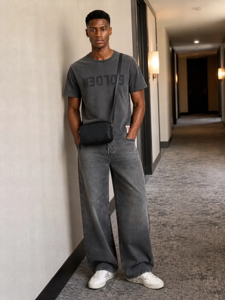 Golden Goose sneakers and the washed charcoal tee set a quietly graphic base, all in soft greys and off-white. The high-rise wide-leg denim brings a stronger streetwear silhouette, letting the shoe and print breathe. Gucci’s compact dark crossbody finishes it with just enough logo to read luxury without breaking the laid-back mood.