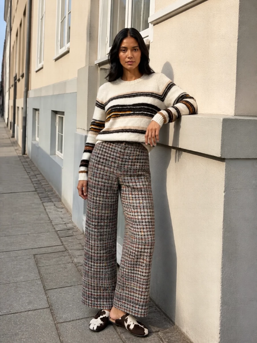This outfit leans into a cozy boho story built around the Marni mules, with Missoni’s cream striped knit and softly checked wide-leg trousers creating a rich mix of pattern that still feels grounded in neutrals. The interplay of cream, espresso and muted copper keeps everything cohesive while the wide-leg silhouette and cropped, boxy jumper balance each other proportionally. I chose the top and bottom route rather than a dress to echo the mule’s playful texture with layered knitwear and give you a more relaxed, lounge-to-city feel rather than a single refined column.