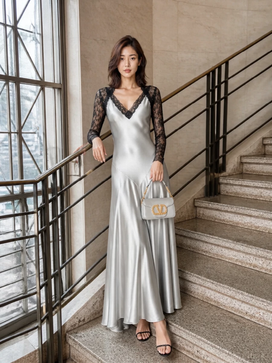 This is a silver-and-black evening story built around fluid romance and precise shine. The Alberta Ferretti gown picks up the Valentino clutch’s metallic glimmer in a softer, liquid way, while the lace sleeves keep it sensual rather than loud. Aquazzura’s crystal-fine sandal simply traces that light down the body, so every line feels elongated, polished and ready for a winter gala or black-tie dinner.