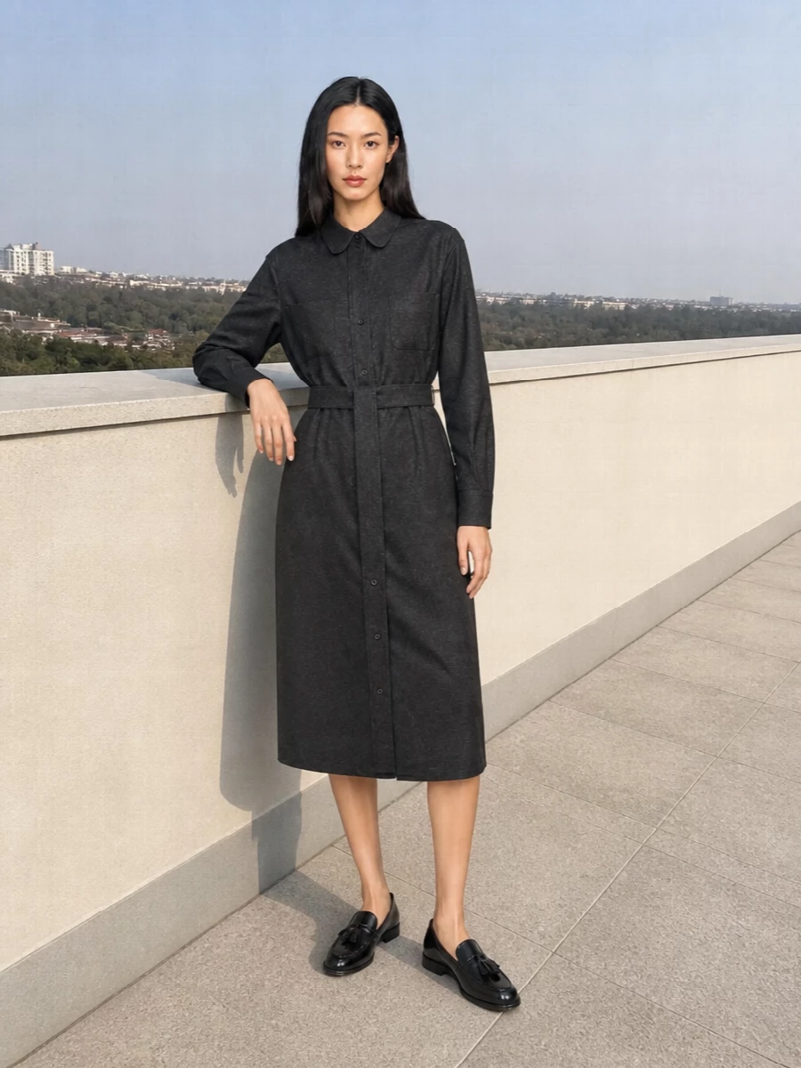 A precise charcoal shirtdress sets a quiet, tailored foundation that speaks directly to the Tod’s tote’s structured, understated mood. Black loafers keep the line clean and grounded, so the focus stays on refined proportions and a calm, neutral palette. It reads as an intelligent city uniform, polished without feeling over-styled.