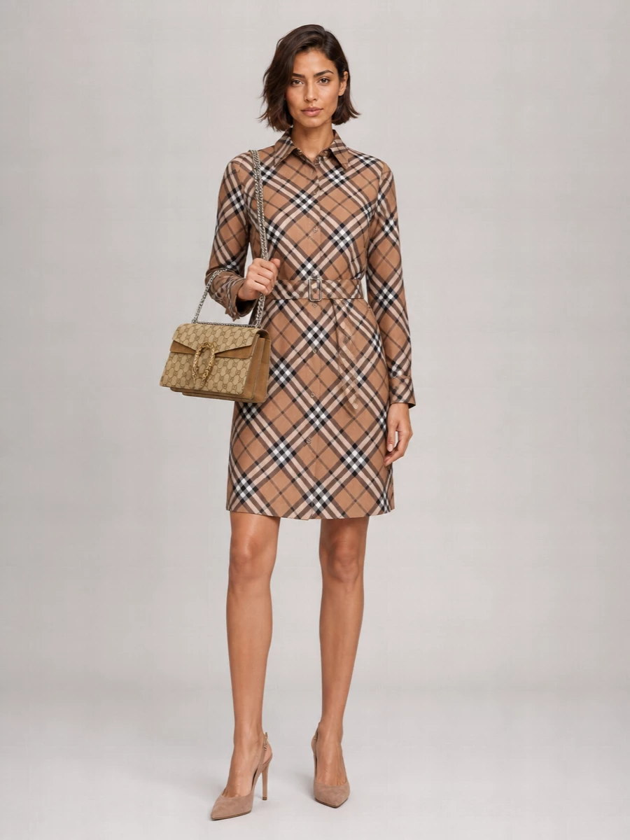I chose the dress route here, letting the Burberry checked shirt dress carry the preppy, heritage message in one clean line that harmonizes with the Gucci bag’s sand canvas and antique gold hardware. The knee-length, belted silhouette feels polished but not stiff, and the taupe suede slingbacks keep the proportions refined while quietly echoing the bag’s warm neutrals. It’s a boardroom-to-brasserie outfit that reads considered, confident, and unmistakably classic without feeling over-styled by separates on top and bottom.