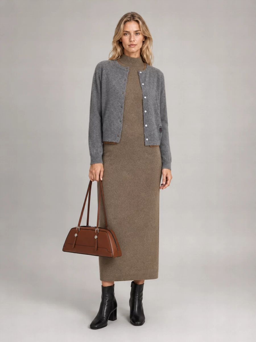 I chose the dress route, letting the Marni cardigan act as a softly structured jacket over a single, uninterrupted knitted column. The taupe midi dress, sculptural black ankle boots and chestnut shoulder bag create a calm, tonal story of greys and browns that feels polished but unfussy for cool-season city days. The proportions stay clean and leg-lengthening, with the cropped cardigan and high neckline working together to give a subtly boyish, considered finish.