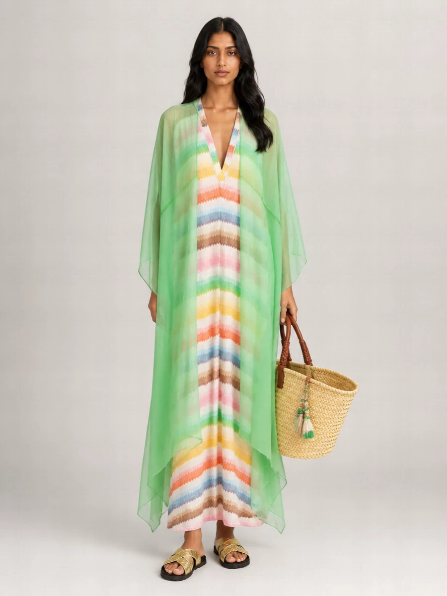 I’m treating the green Dries poncho as a dramatic outer layer over a single base dress rather than building top and bottom, so the silhouette stays long, fluid and romantic instead of visually overworked. The Missoni chevron kaftan underneath keeps the mood beachy, boho and light, with sorbet stripes that sing against the vivid green rather than fight it. Gold cross‑strap slides and an artisanal straw basket finish the story with easy glamour that feels perfect for sun‑drenched resort afternoons that drift into cocktails.