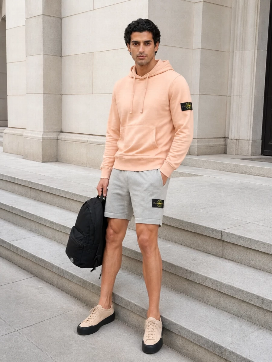 Soft peach and light grey keep this Stone Island set easy for warm days, with black accents grounding the colour in a clean street-sport mood. Technical runners and a streamlined backpack keep everything practical for real city movement while staying visually tight and minimal. It reads relaxed but intentional, ideal for off-duty time that still feels put together.