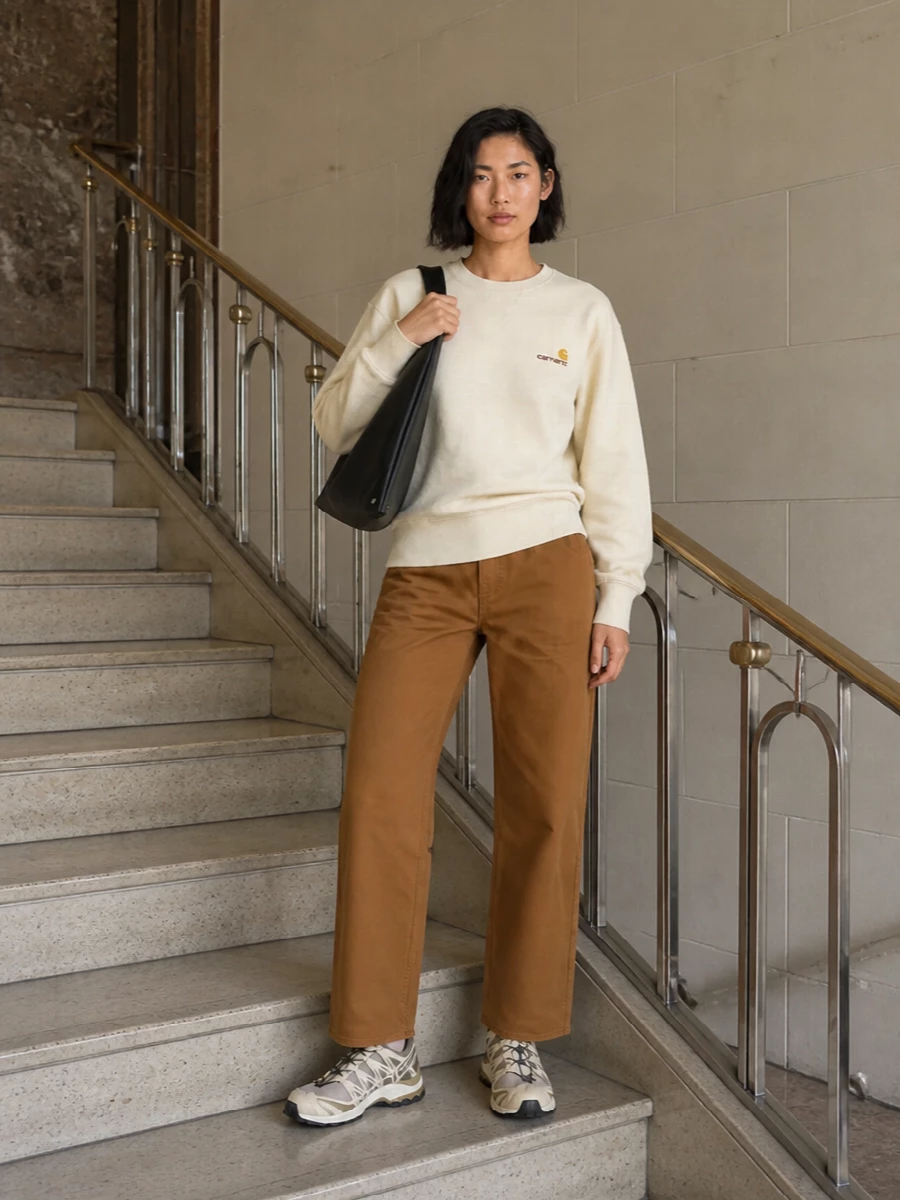 Buttercream and caramel sit together here in a clean workwear-inspired base, keeping the mood relaxed and unfussy. Technical runners bring a subtle streetwear hit while staying muted, and the sculptural black tote finishes things with a practical, directional edge. It is an easy, all-season uniform that feels quietly put together without trying too hard.