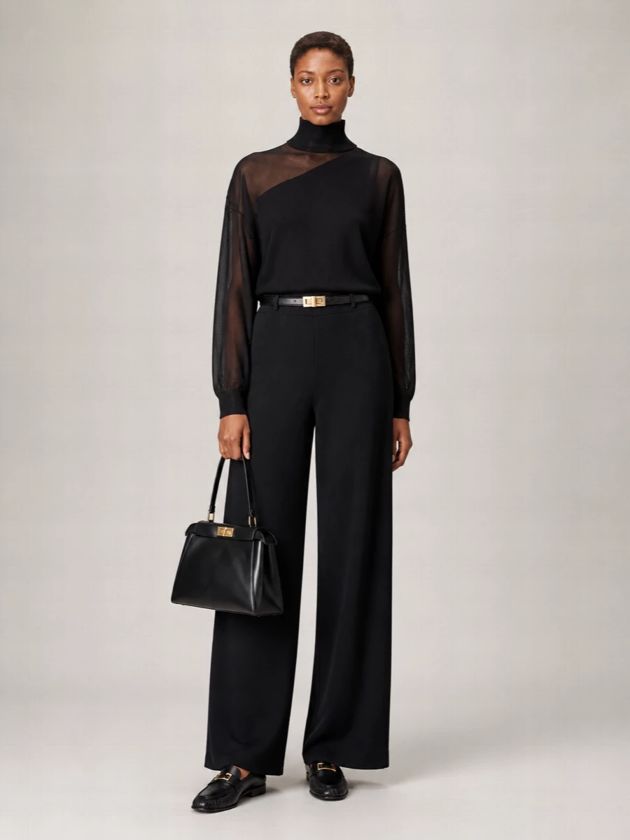 A pure black column in wide-leg jersey and a sheer asymmetric knit feels quietly sensual yet restrained, ideal for evenings that do not need high heels. A structured black top-handle and polished loafers sharpen the softness, keeping the mood city-appropriate while still deeply relaxed. A slim double-wrap belt just hints at the waist so the silhouette stays long, languid, and unmistakably luxurious.