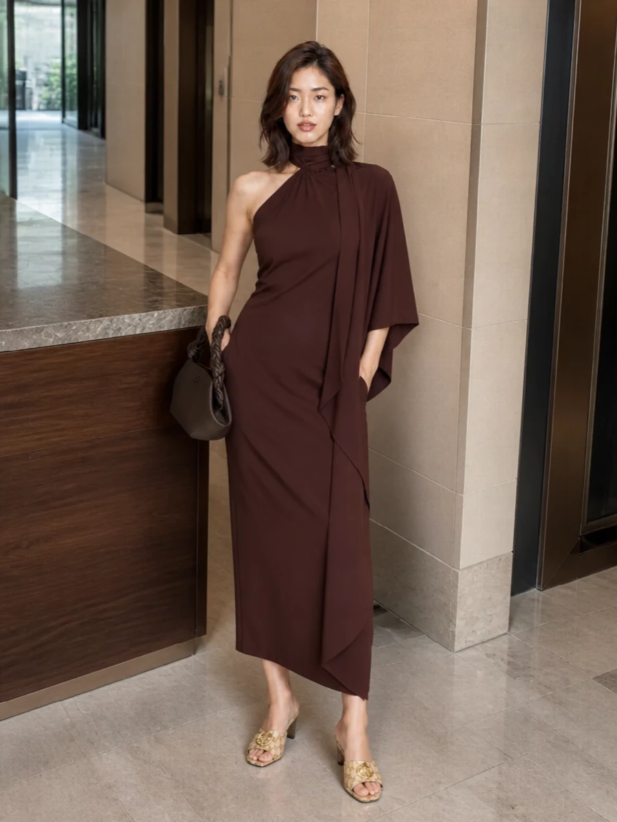 I’m anchoring this around the one-shoulder chocolate midi, which lets the warm neutrals of the Gucci mules feel intentional rather than incidental. The column shape and rich brown palette keep everything in a quiet, grown-up register, while the sculpted leather clutch adds texture and structure without breaking the softness. It is an easy dinner-and-drinks ensemble that reads luxurious but relaxed, all in tonal neutrals with just a whisper of gold hardware.