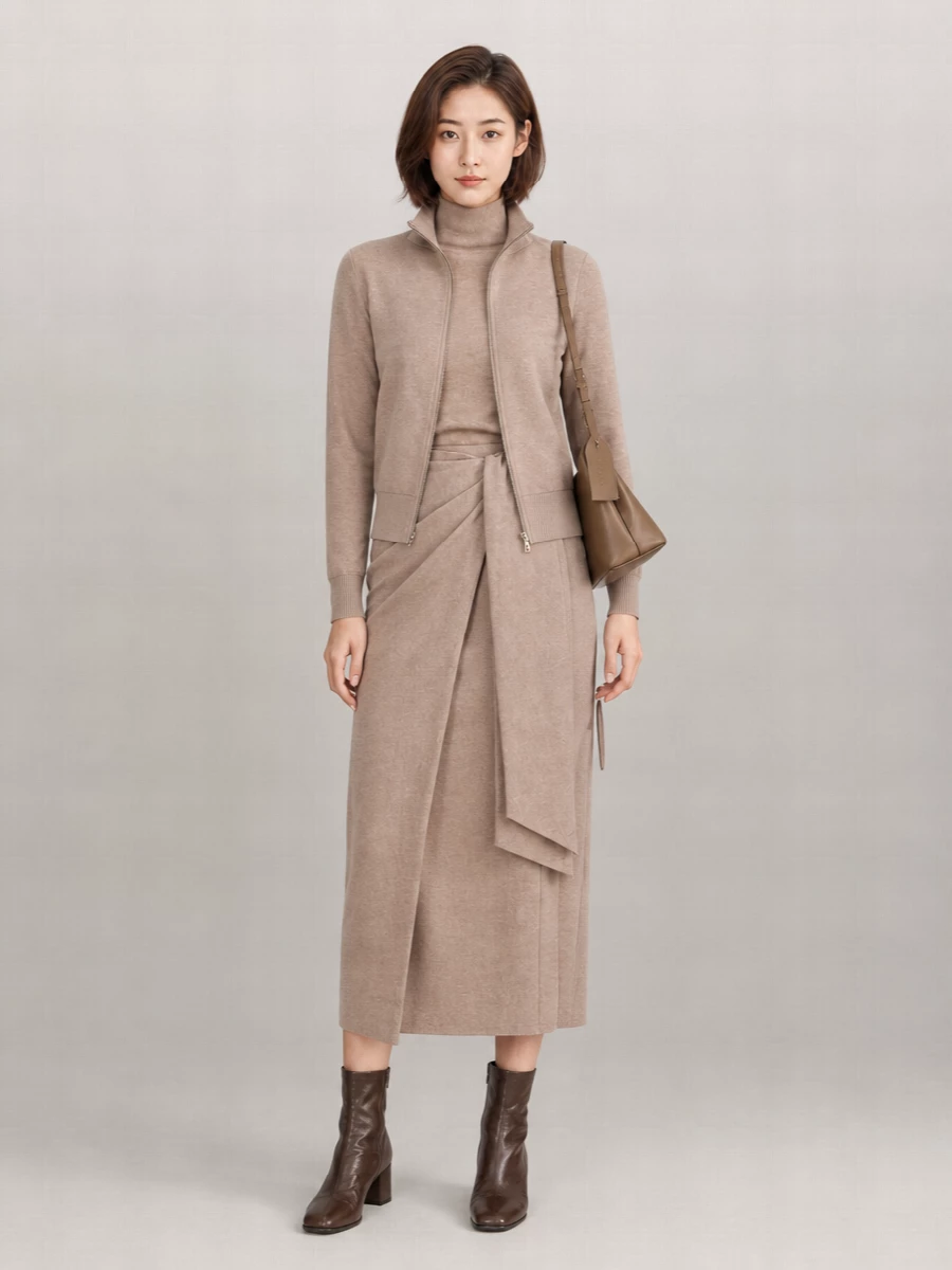 I’m anchoring this with the knit wrap dress rather than separates, so you get a clean taupe column under the zip-up and a very deliberate, modern knit-on-knit story. The Margiela ankle boots sharpen the softness with a deep, grounded base, while the taupe shoulder bag threads the neutrals together without breaking the quiet, off-duty polish. It is the kind of city outfit that feels as easy as loungewear but reads considered from coffee meetings to low-key dinners.