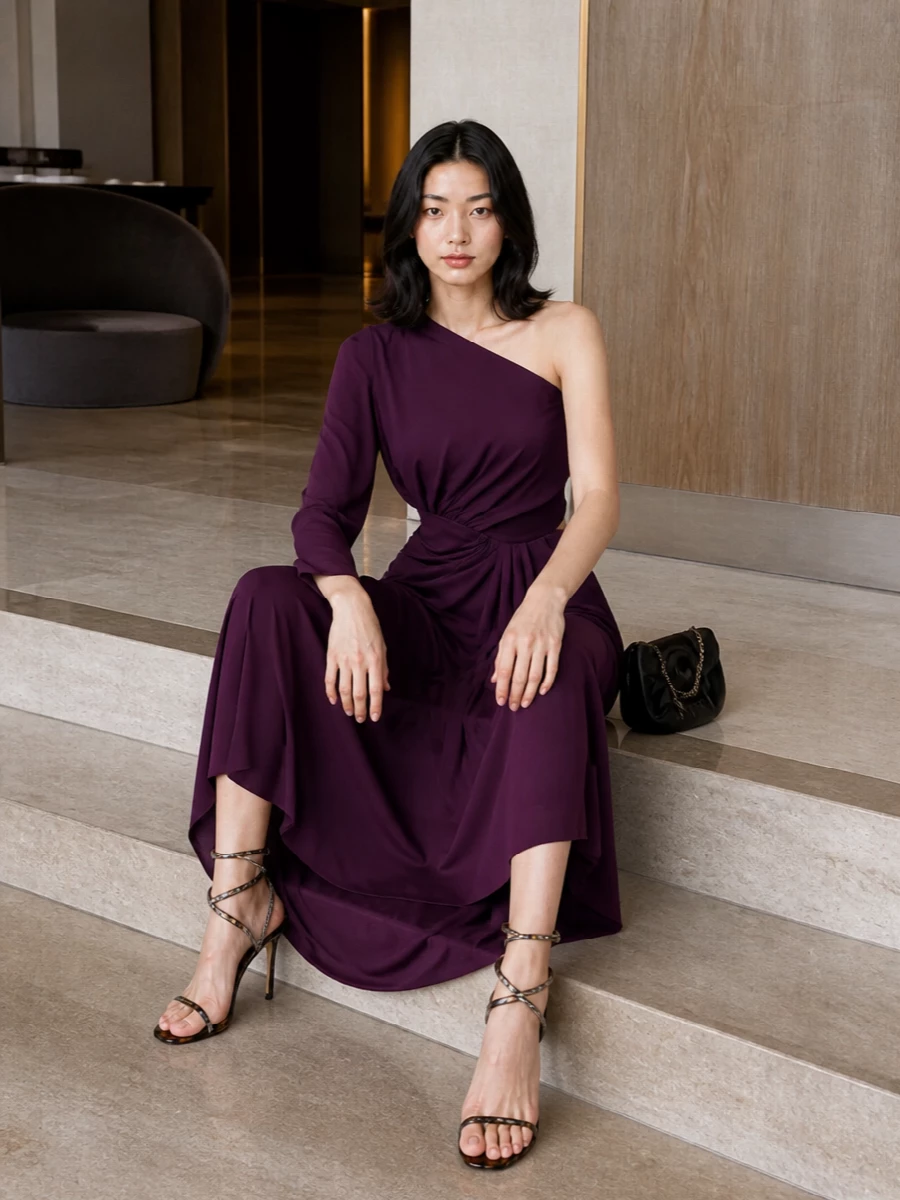 For this sandal, a dress route feels more coherent than separates, so the plum Giambattista Valli gown becomes a statuesque, romantic foil to the tortoiseshell spiral. The asymmetric neckline and rich color play beautifully against the shoe’s sculptural line, creating a sensual, after-dark silhouette. A sculpted black clutch finishes things with quiet polish, letting the gown and heel hold the spotlight.