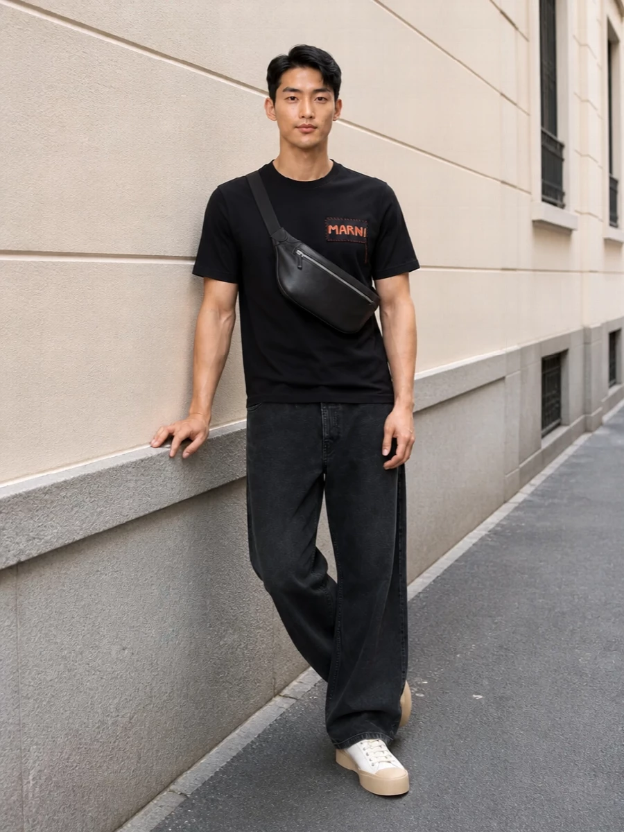 A black Marni tee and washed wide-leg trouser create a clean, graphic base with just enough art-school attitude. Chunky off-white sneakers break up the darkness and keep the proportions grounded and modern. A padded black crossbody adds subtle structure and texture while keeping the whole thing easy for city days.