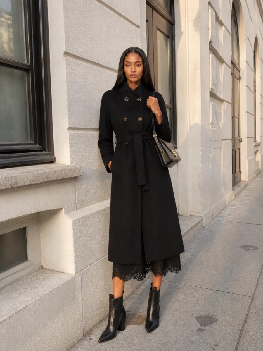 I chose the dress path to preserve a pure, elongated black column under the Valentino coat, which feels more coherent and quietly formal than breaking the line with separates. The scalloped lace hem and sculpted ankle boots introduce just enough texture and sharpness, while the structured shoulder bag and gold hardware echo the coat’s buttons for a tightly edited, minimalist evening ensemble. The result is winter gala ready, but still restrained and modern.