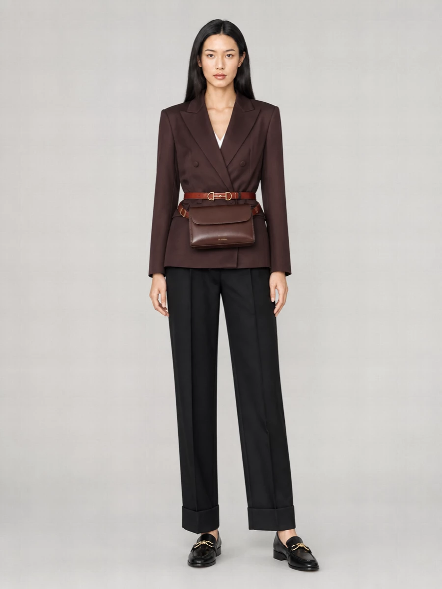 I chose the top and trouser route rather than a dress so the Gucci belt can genuinely define the waist and sit in dialogue with sharp tailoring. The chocolate blazer, high-rise black trousers, gold-linked loafers and sculpted belt bag create a long, clean line in black and deep browns, with the brick belt as the single, intentional color accent. It reads like modern city suiting that is quietly luxurious rather than loud, ideal for days that move from meetings into dinner.