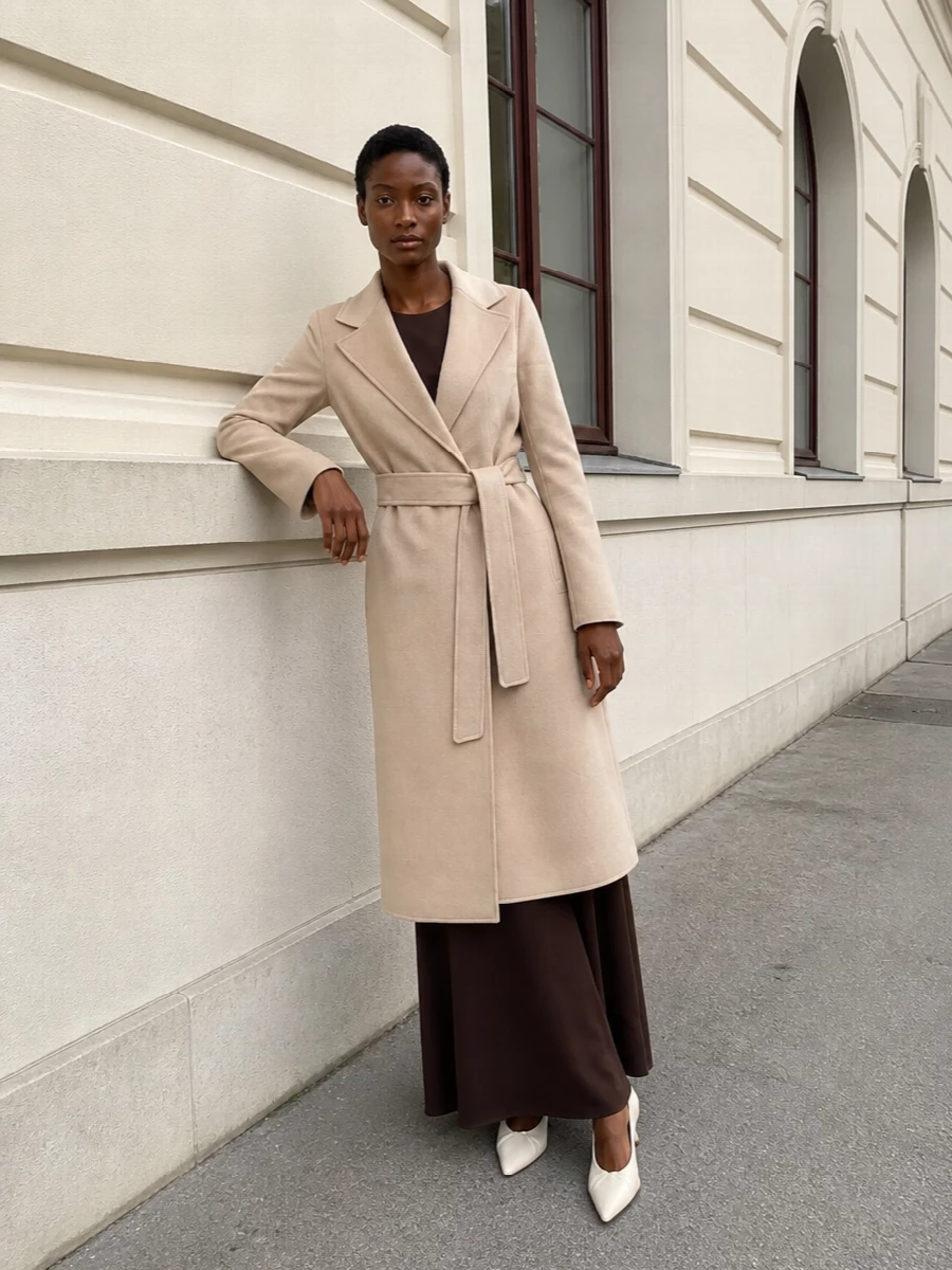 I am anchoring this with the dress rather than separates, because the column silhouette of the Max Mara maxi gives a more coherent, elongated line under the belted midi coat than any trouser option. The deep chocolate dress, light-beige coat and ivory slingbacks create a nuanced neutral story that feels polished enough for serious daytime meetings yet calm for dinner. The camel tote keeps it purposeful and quietly expensive without adding visual noise.