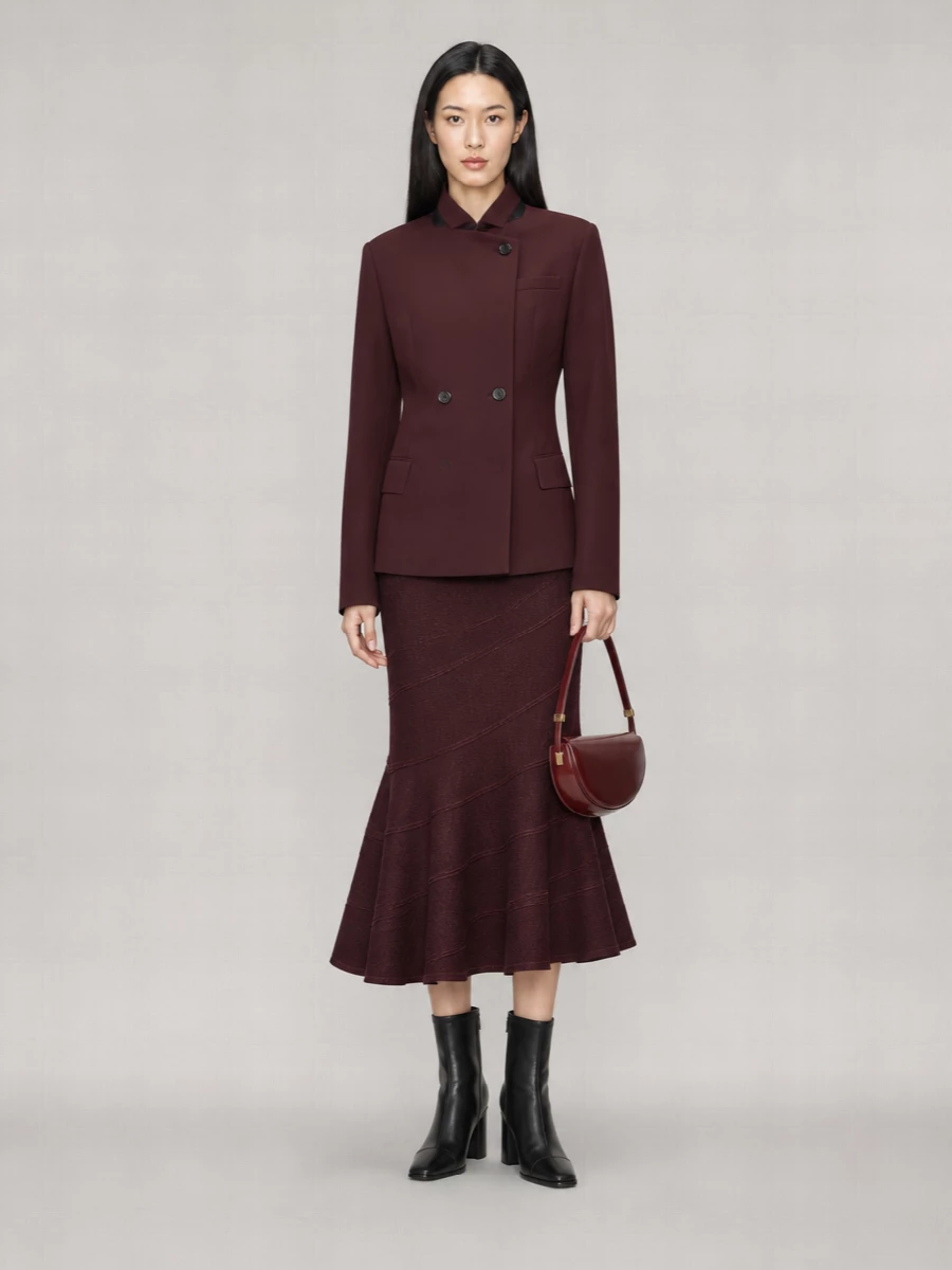I chose the dress route to let the burgundy coat sit over a clean, uninterrupted column rather than competing with a second tailored layer. The Self-Portrait knit wrap midi echoes the coat’s oxblood tone and slim structure, so you get a rich monochrome with subtle texture shifts instead of contrast. Grounded with black leather ankle boots and a sculpted burgundy shoulder bag, the result is a city-ready evening ensemble that reads precise, confident and quietly indulgent for cooler seasons.