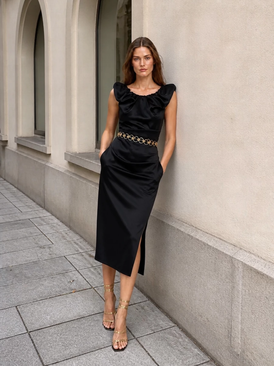 This is an after-dark, romantic cocktail ensemble built around the Versace chain belt as a piece of waist jewelry. The sculpted Vivienne Westwood dress gives the perfect canvas for the gold hardware, while Gianvito Rossi’s strappy stilettos and a sharp Saint Laurent clutch keep the line elongated and polished. I chose the dress route over separates to avoid visual clutter and let the belt’s circular links be the singular, glamorous focus against clean black.