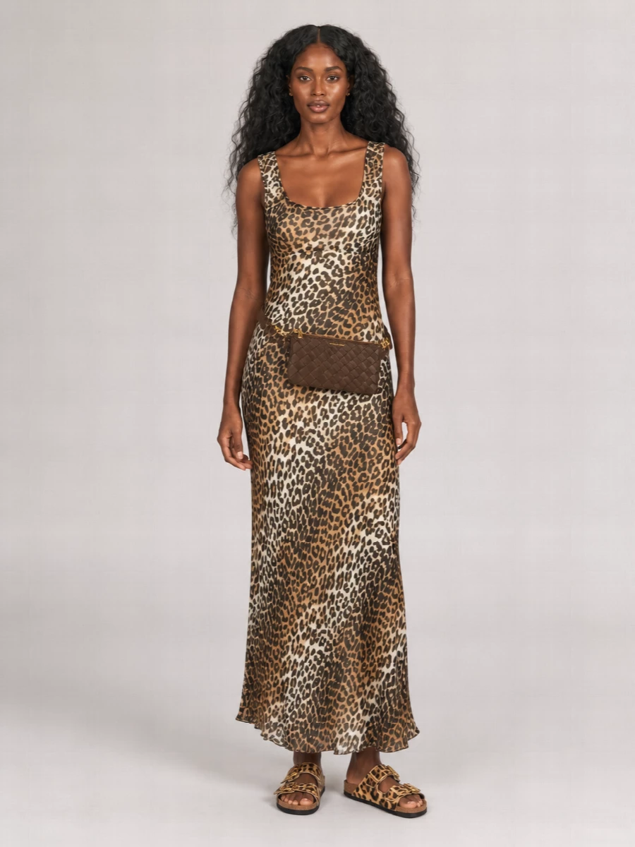 This is a print-forward, easygoing city outfit built around the slinky Ganni leopard maxi and the Birkenstock slides, both in warm tan and brown tones. Let the dress do the talking, then cinch the Michael Kors chocolate belt bag at the waist or hip for balance and a cleaner line against all the pattern. Choosing the dress route keeps the animal print intentional and chic instead of chaotic, while the flat sandals keep the whole thing relaxed and wearable from day through low-key evenings.