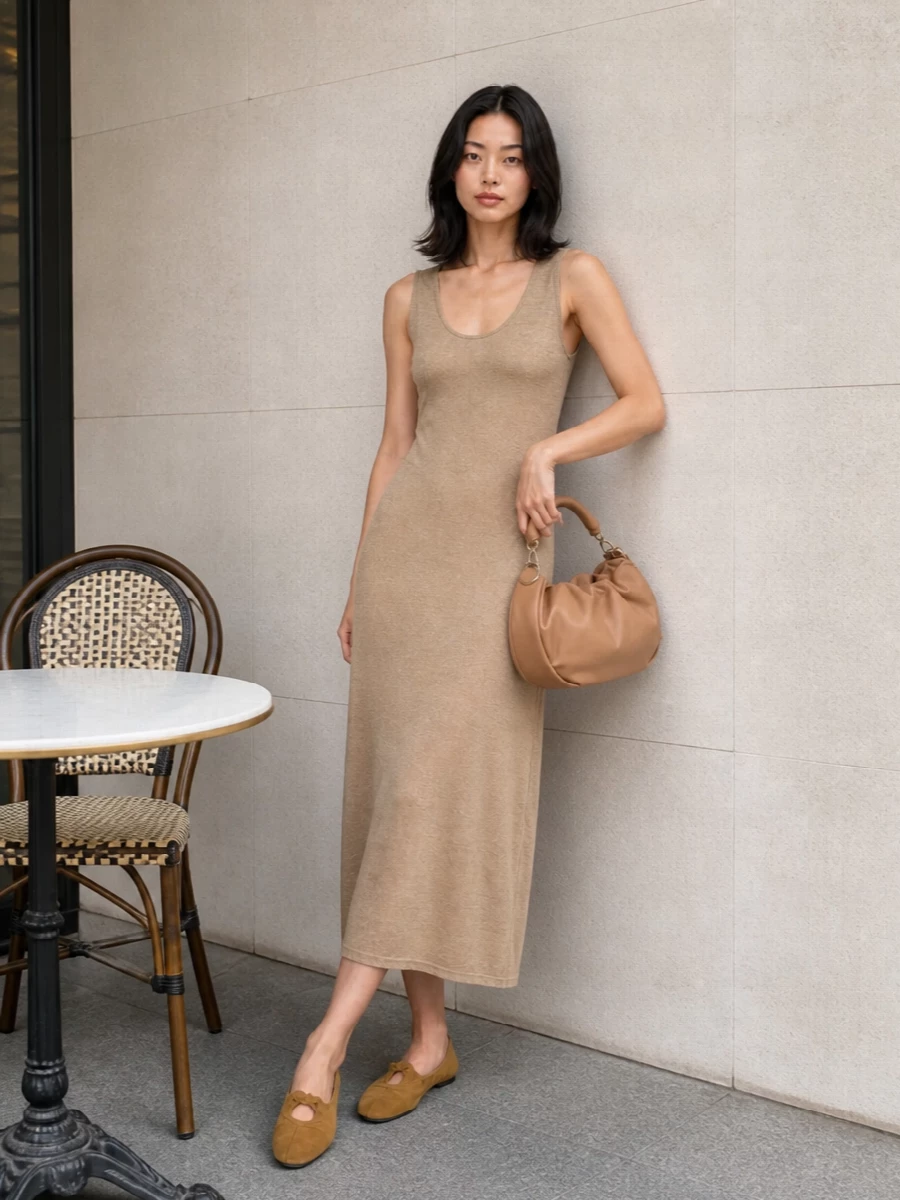 The knit midi dress route is stronger here than a top and skirt, because its clean column line and warm beige tone harmonise directly with the soft mustard ballet flats. Together they create a low-contrast, elongated silhouette that feels relaxed yet considered, ideal for warm days when you want quiet polish without fuss. The caramel crescent bag adds a subtle sculptural note while staying within the same sun-faded neutral family, keeping the whole outfit cohesive and understated.