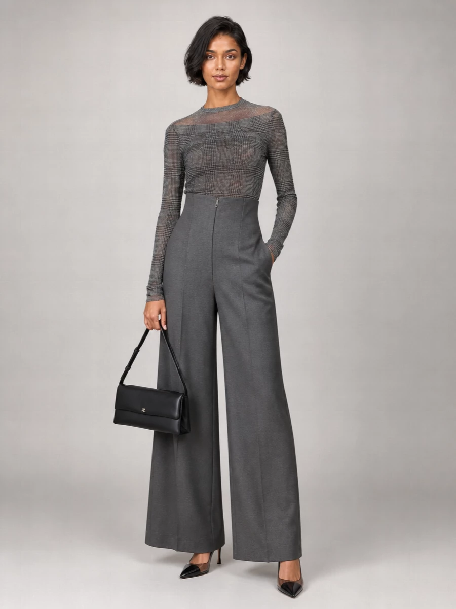 Charcoal tailoring gets a Gaultier twist here, with the sheer checked mesh top anchored by sculpted high‑waist wide‑leg trousers for a long, clean line. Smoky PVC slingbacks and a slim, structured shoulder bag keep everything razor focused and modern, while a whisper‑light monogram scarf adds just enough texture for night.
