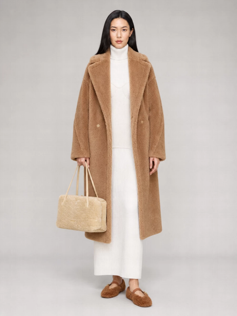 I chose the dress path to let the Max Mara teddy coat sit over one clean column rather than compete with tailoring, which keeps the volume intentional and the mood serene. The Gaultier ivory ribbed maxi, caramel Ferragamo flats and Jil Sander shearling tote build a tonal winter story of camel and cream that feels quietly expensive rather than overtly styled. Head-to-toe texture with a long, uninterrupted line gives you warmth, height and discretion in one move.