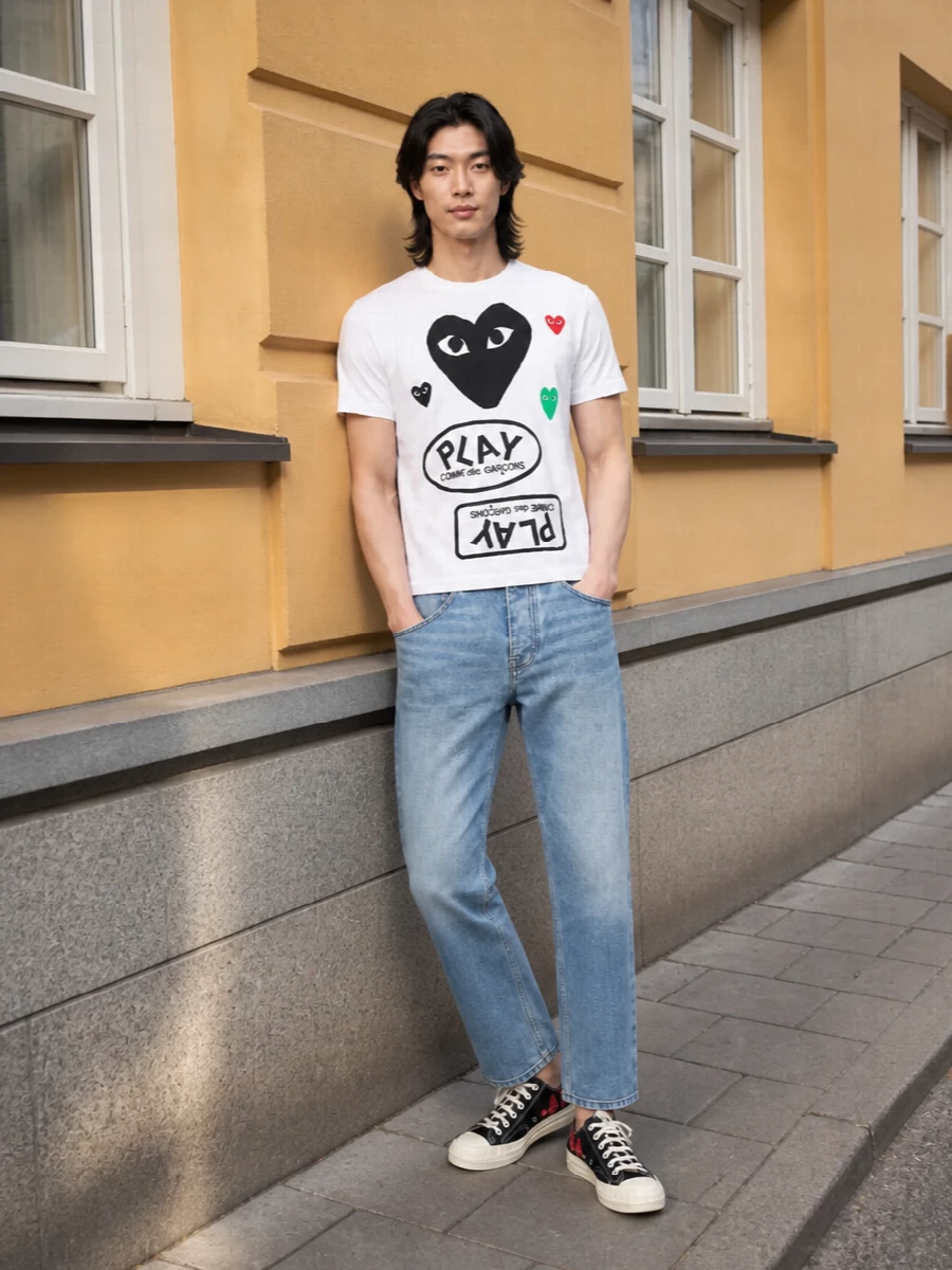 Graphic CdG energy sits on a base of light, skate-leaning denim for a clean, easy street take that still feels considered. Black Play sneakers and the slim CdG pouch tighten the story into a focused white, black and red palette. The result is casual and young but quietly pulled together enough for city days and low-key nights out.