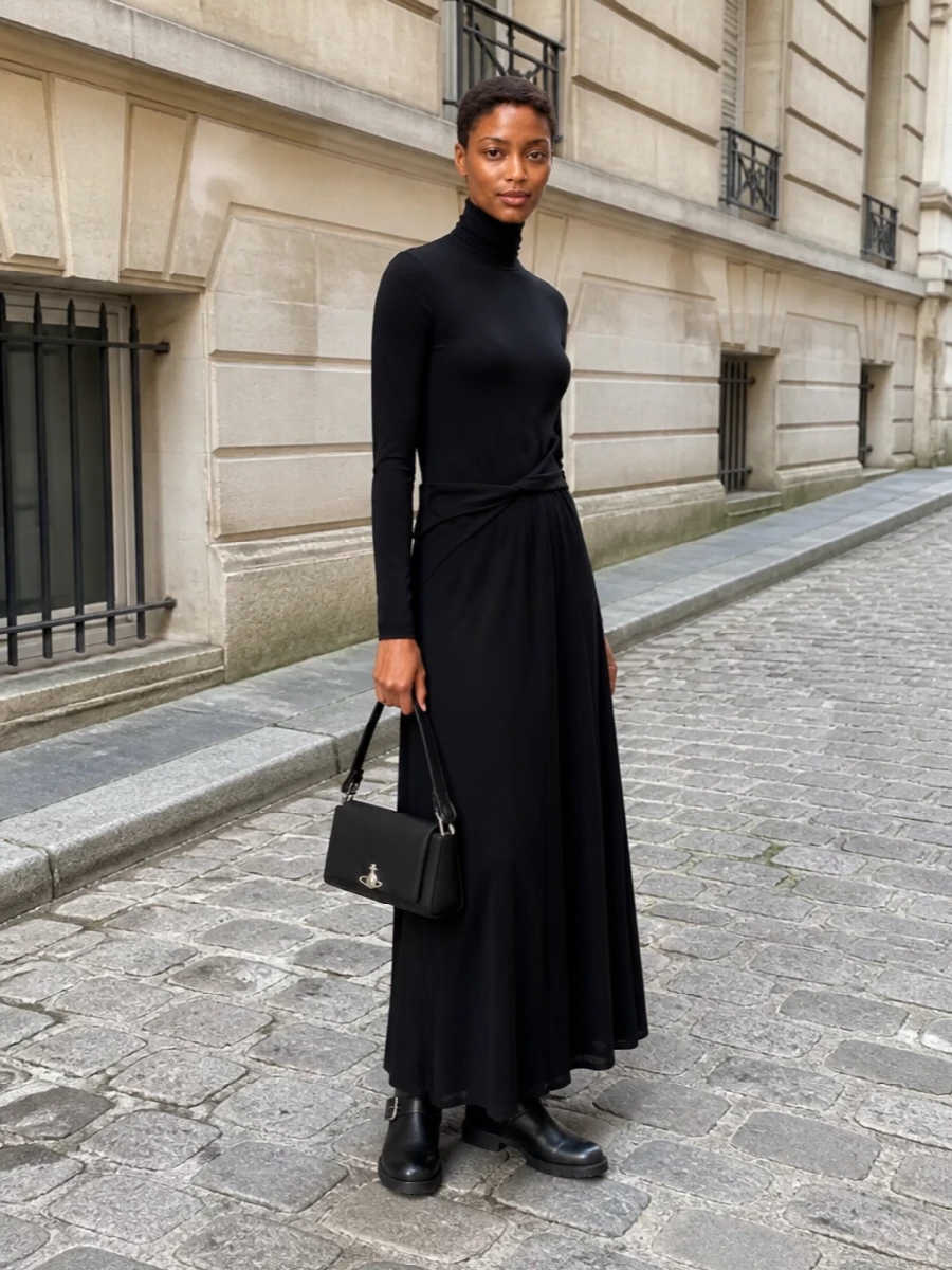 I’m anchoring this with the long Fabiana Filippi knit dress rather than separates, because its clean column and high neck echo the bag’s pared-back drama and feel right for cool-season evenings. The Stella McCartney biker boots bring in just enough hardware and attitude to keep the all-black story modern, while still reading quietly polished next to the structured baguette. Together you get a minimalist, city-ready outfit that moves easily from dinner to late bar without ever feeling over-styled.