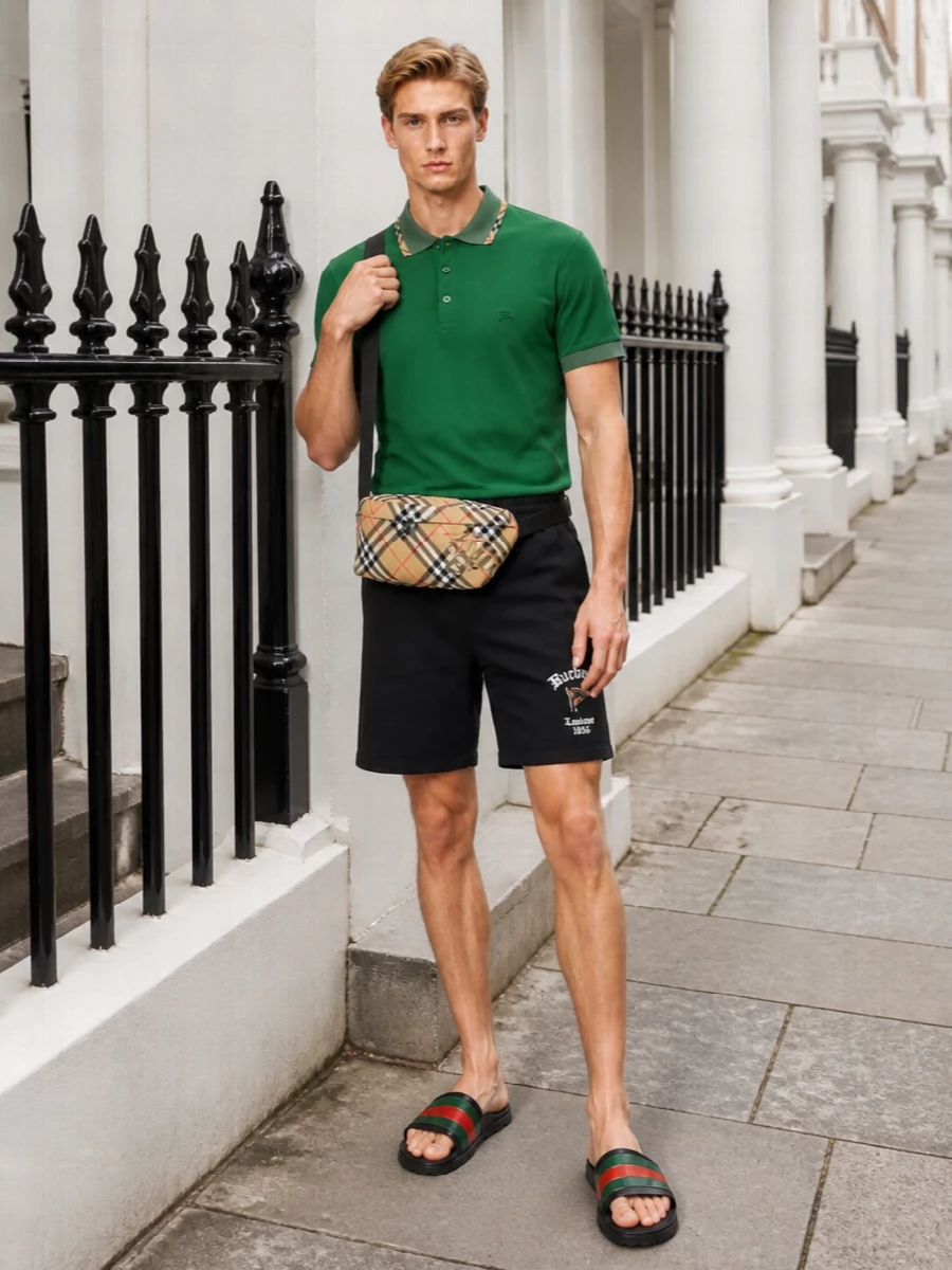 Gucci slides stay in focus against a sharp Burberry pairing: a forest green polo up top and clean black logo shorts below for a grown‑up take on athletic prep. The Burberry check belt bag adds just enough pattern and heritage color to echo the sandal’s stripe without overwhelming the relaxed, sport‑leaning silhouette.