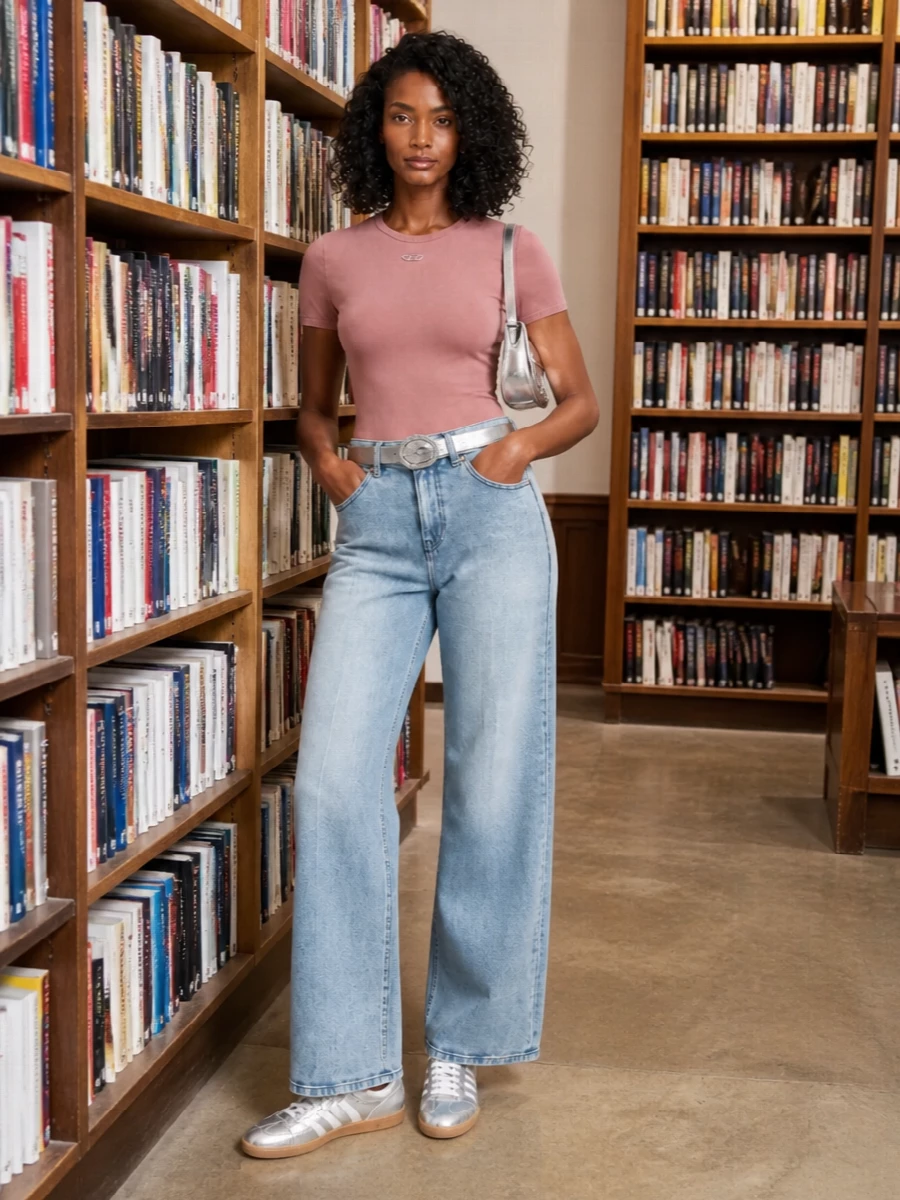 Dusty rose and sun-faded blue denim set a soft base, then chrome details pull it firmly into a Y2K city mood. The high-rise wide leg feels relaxed but intentional, with a metallic belt and silver accessories catching the light just enough. Sneakers keep it easy for all-day wear while the mirrored bag quietly hints at after-hours plans.
