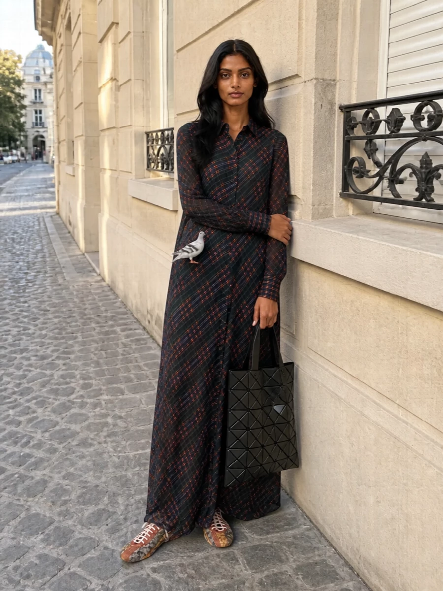 This reads like a gallery-going city uniform: the sheer Dries plaid column, graphic Bao Bao tote and snakeskin Dries sneakers all riff on the pigeon charm’s witty, artful spirit. The palette stays in deep, moody tones so the key piece and shoes provide the offbeat color and texture, keeping the mood boho-intellectual rather than literal streetwear. A dress route works best here, because the long, fluid line of the shirt dress gives the right canvas for that tiny sculptural bird to feel intentional and curated, not just cute.