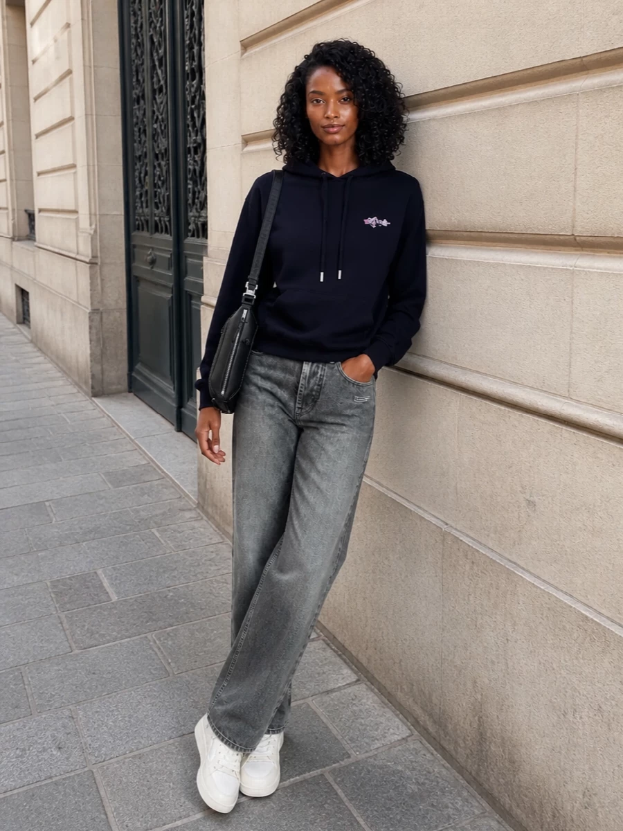 This look leans into polished streetwear: the deep navy Off-White hoodie sits relaxed over washed charcoal straight-leg jeans for an easy, elongated line. Clean off-white low-top sneakers keep the palette light and graphic, while the structured black Loewe crossbody adds a sharp, designer finish that still feels effortless for city days.