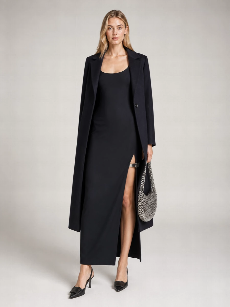 A deep navy column with a side-slit meets razor-sharp black slingbacks for a clean, nocturnal silhouette. The chainmail shoulder bag adds liquid light and a subtle y2k hit, keeping the mood modern and nightlife ready. Everything stays minimal in shape so the cut of the dress and the hardware details stay in focus.