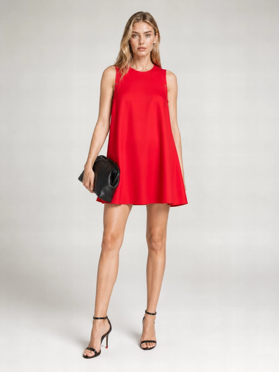 A vivid red mini takes the lead, cinched with a fine black belt so the volume feels intentional rather than sweet. Razor-slim black stilettos and a soft framed clutch keep the line clean and grown up, all graphic contrasts and quiet hardware so the color reads strong and modern for gallery nights or late dinners.