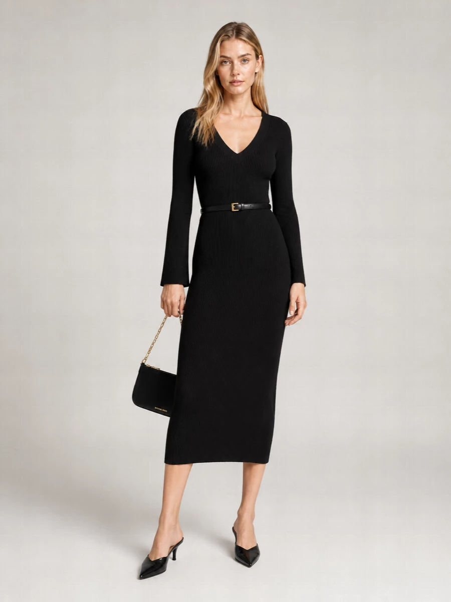 A sharply cut black ribbed dress is paired with pointed black kitten mules for a long, uninterrupted line that feels ready for dinner or after-hours. A slim black shoulder bag and discreet gold belt echo the hardware at the waist, keeping the palette strict and the mood quietly polished. The result is a clean cocktail outfit that reads modern, minimal and intentionally sleek from every angle.