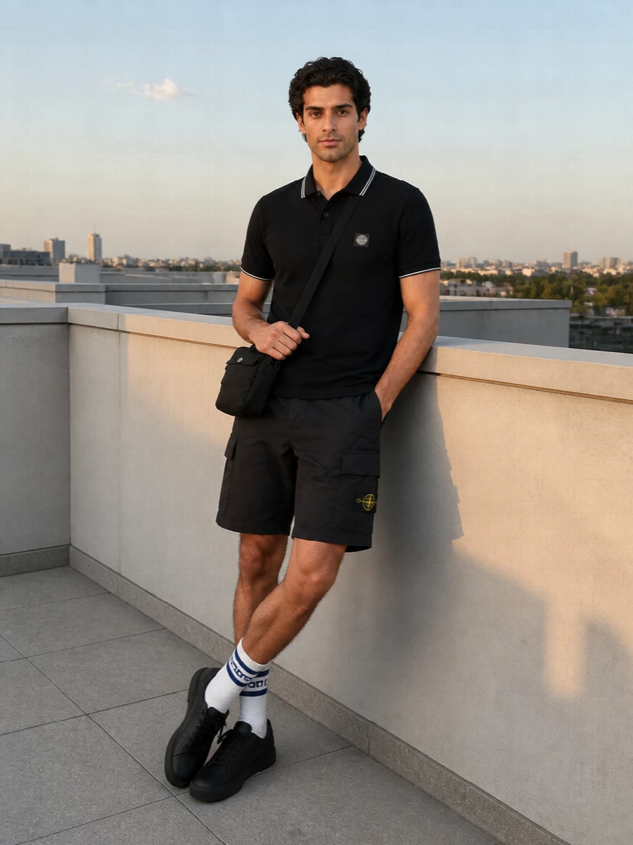 A sharp black Stone Island polo pairs with matching cargo shorts for a clean, athletic city uniform grounded in technical fabrics. All-black sneakers and a compact crossbody keep the profile streamlined, while off-white striped socks add just enough contrast and sport detail. The result is easy, logo-driven streetwear that moves from daytime errands to casual nights out without a change of pace.