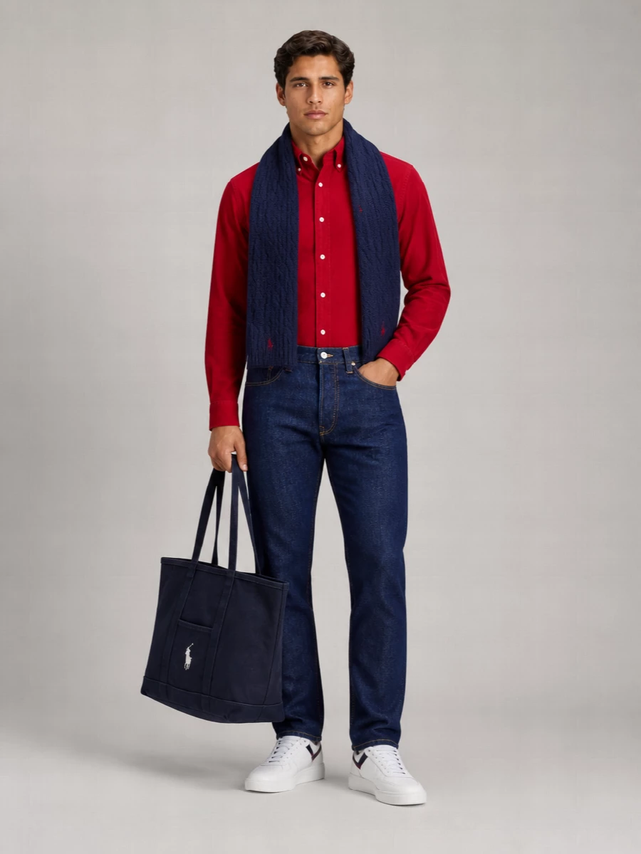 Crimson cord and dark indigo set a classic Polo-on-campus mood, with the shirt doing the talking against clean, straight-leg denim. White low-profile sneakers and a structured navy tote keep everything sharp but easy, while the navy cable-knit scarf pulls the palette together for crisp autumn days. It is relaxed enough for weekend plans yet considered enough for casual Fridays or dinner in town.