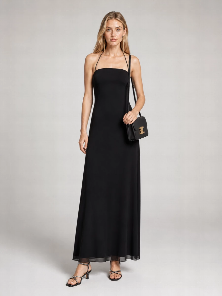 I’m building this around a single, pure column so the Saint Laurent tassel earrings can really register as the one piece of overt drama. The Row’s halter dress, pared-back Jil Sander sandal, and compact Celine bag keep everything in a black-and-gold, quietly polished register that feels very Paris at night without any noise. It is evening dressing that reads powerful, not performative, and will work just as well under a sharp tuxedo coat if you want another layer later on.