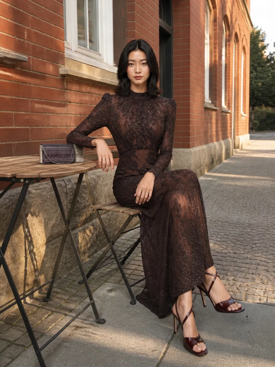 The chocolate Self-Portrait lace gown and oxblood Jimmy Choo sandal create a deep, tonal evening story that feels romantic rather than shouty. Sheer detailing and subtle sequins keep it sensual but contained, with the column silhouette balancing the stiletto’s drama. The ombré plum clutch ties the browns and burgundies together, adding a final glint of light in the hand.