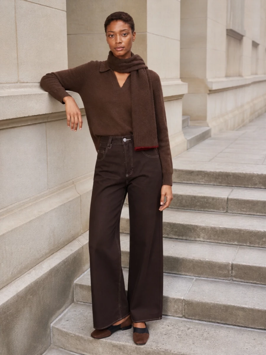 Chestnut and deep chocolate sit in the same low-key register here, creating a long, calm line from the polo through the wide-leg denim. The square-toe ballerinas and softly structured suede tote keep everything grounded in texture rather than hardware, so the effect is thoughtful and quietly confident from desk to gallery. A slim brown scarf ties it together for colder days without disturbing the clean proportions.