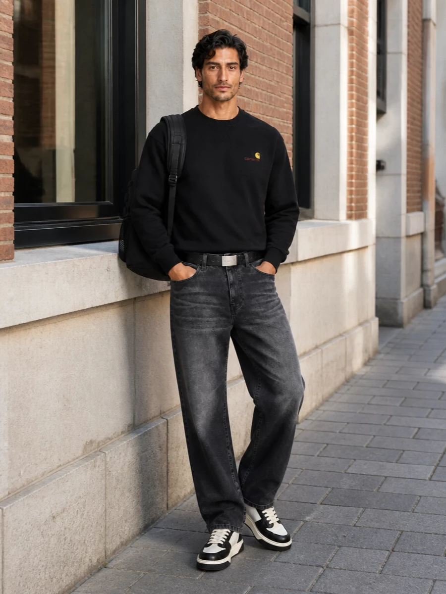 Black-on-black Carhartt pieces set a calm, utilitarian base, with washed denim and a subtle logo hit keeping it grounded in street culture rather than overt branding. The black and off-white sneakers echo that restraint while adding a lighter note, and a tactical backpack plus slim belt pull everything into a clean, all-day city uniform. It feels considered but not precious, built to live in from morning commute to late-night walks home.