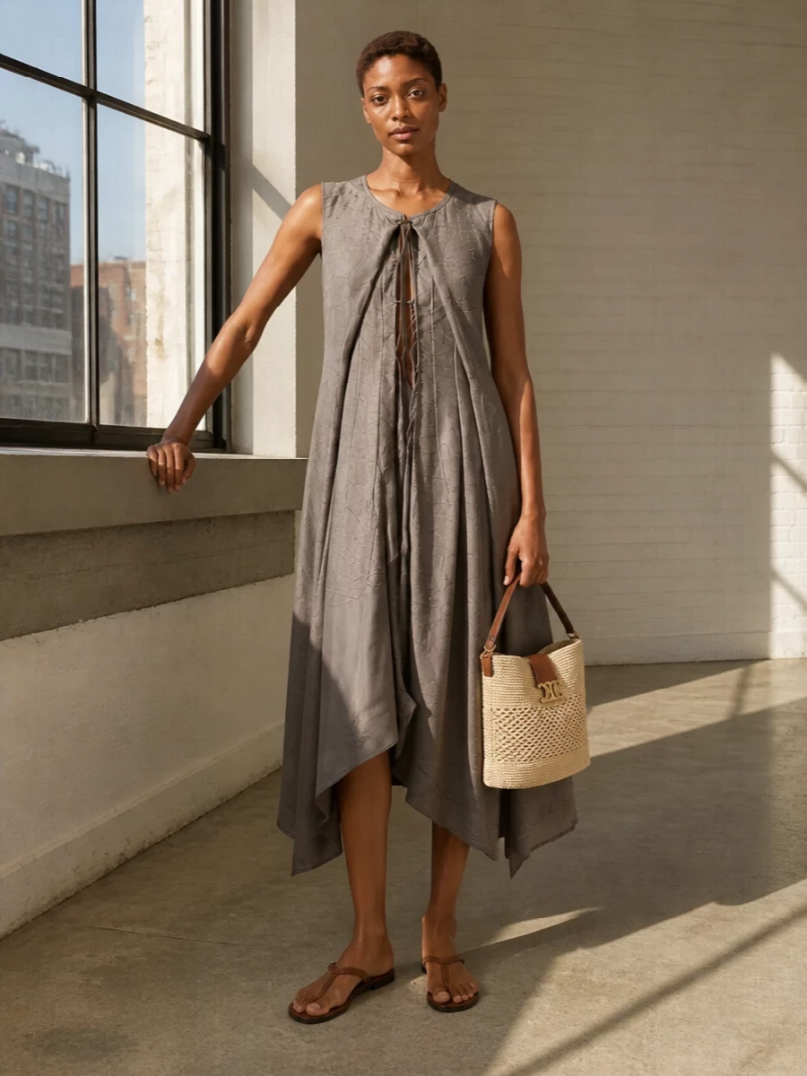 I’m taking the dress route here to keep the mood clean and modern around the structured raffia bag, avoiding the extra seams and layers of a top and trouser that could overcomplicate it. The Margiela taupe midi and dark chocolate flat sandal create a long, minimal line in warm neutrals that feel city-ready yet relaxed. The result is an understated column of texture and movement, with the bag’s straw and leather adding just enough Riviera ease without breaking the minimalist language.