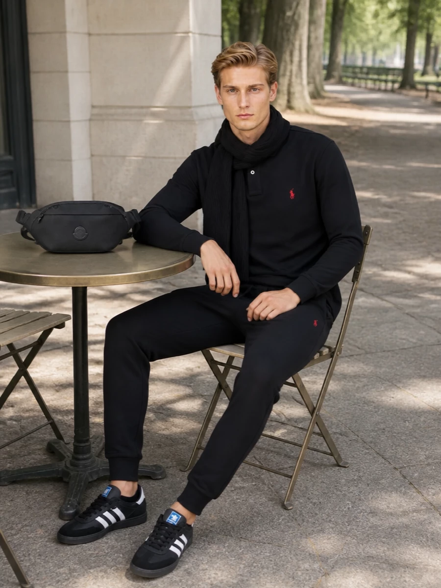 A head-to-toe Polo Ralph Lauren pairing in black with red accents keeps this jogger outfit sharply coordinated without feeling overdone. The long-sleeve polo and terrace-style sneakers balance sport and polish, making it easy for coffee runs, travel days or relaxed city evenings. The slim belt bag and matching knit scarf keep things practical and cohesive while holding the line on clean, logo-led prep.