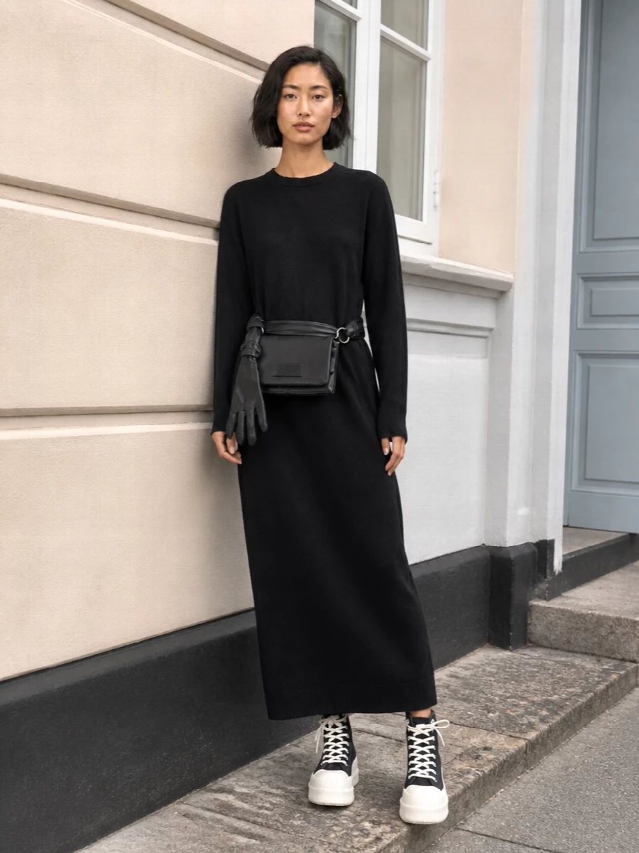 Anchoring everything around the Darkpark knit column dress keeps the story clean, allowing the DRKSHDW platform sneakers to feel intentional rather than literal street gear. The long, straight line of the dress contrasts the stacked sole, giving you that severe vertical silhouette with an off-duty edge. The Mm6 belt bag sits on the waist or hip, adding a subtle conceptual detail that keeps the whole outfit sharp and urban without crowding the shape.
