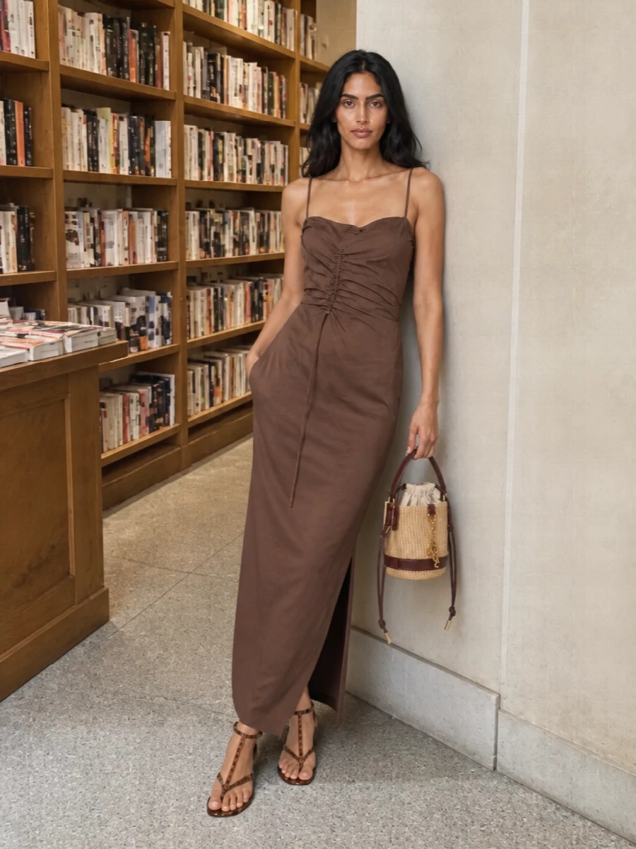 The chocolate Jacquemus slip dress and tortoiseshell Chloé sandals create a warm, elongated line that feels relaxed yet refined for summer evenings. The deep brown harmonises with the sandal’s glossy tones, while the fluid ruching keeps the silhouette soft rather than severe. A compact raffia bucket bag in natural and dark brown finishes the outfit with subtle texture that still sits firmly in a quiet luxury space.