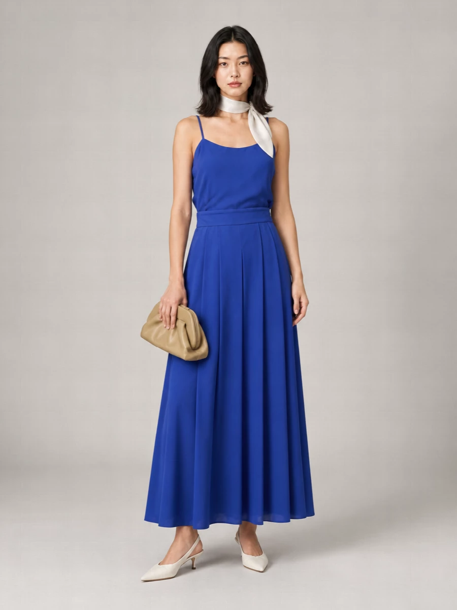 Cobalt takes center stage here, with clean ivory heels and a camel clutch softening the intensity into something quietly romantic for warm evenings. The palette stays minimal but nuanced, mixing cool blue with warm neutrals for a refined balance. A small satin scarf adds just enough shine to feel occasion ready while keeping the silhouette fluid and relaxed.