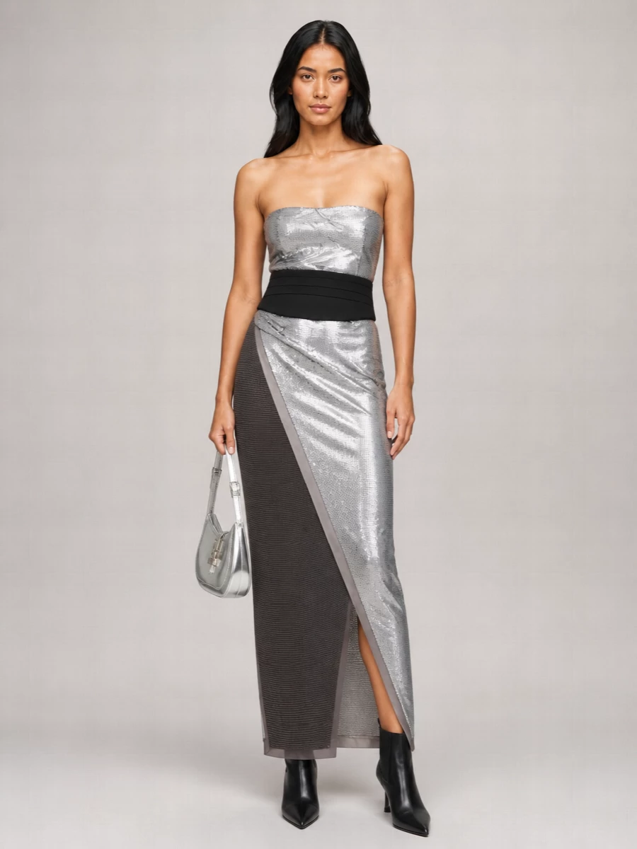 This is pure midnight architecture, all clean lines and controlled shine. The sequinned column is cinched precisely at the waist, then grounded with razor-edged boots and a mirrored crescent bag for a hard, cinematic edge. Every element stays within silver, charcoal and black, so the drama feels intentional rather than busy.