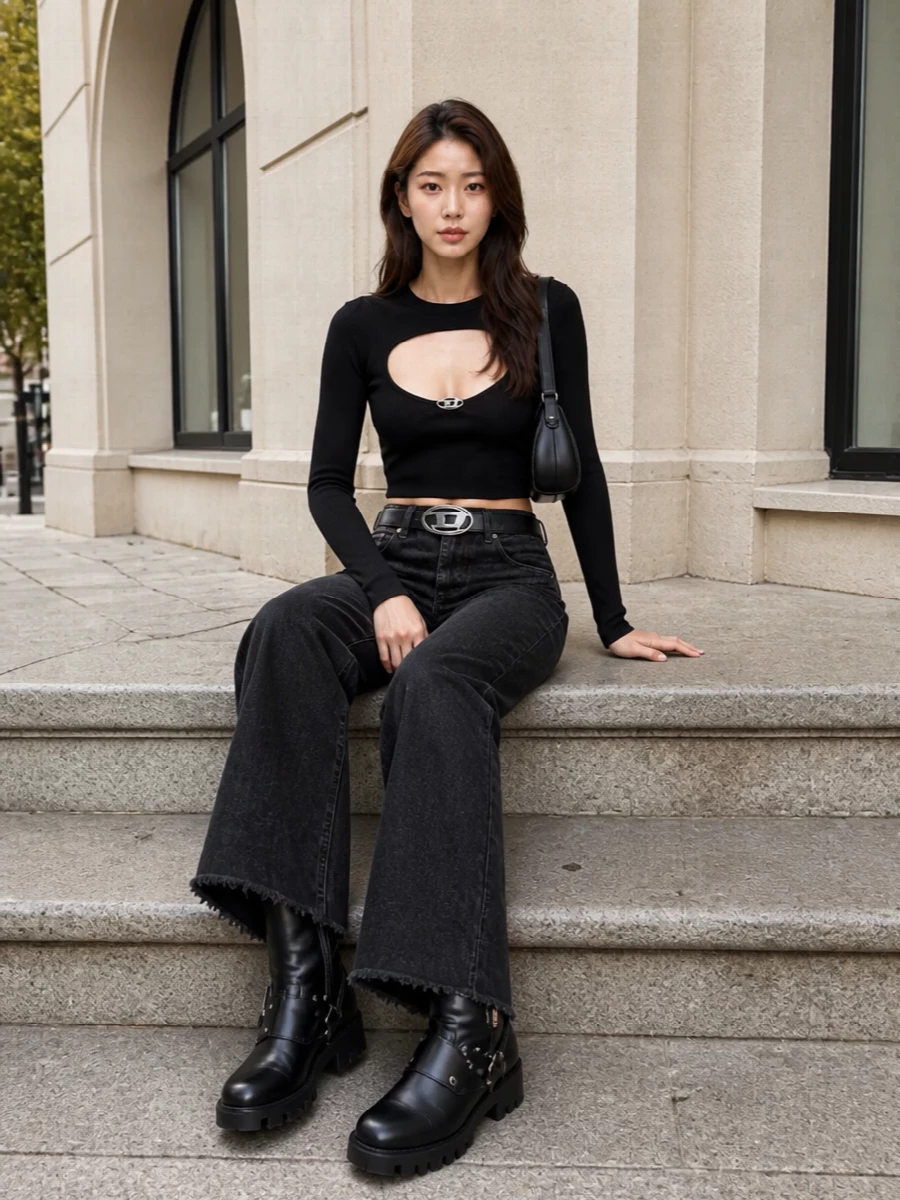 High-rise washed-black wide legs meet a second-skin cut-out top for a sharp, leggy proportion that still feels grounded. Heavy moto boots and a sculpted mini bag stack hardware and texture, while the logo belt crisps up the waist so all that volume reads intentional, not slouchy. It is a gritty, night-leaning denim set that runs from late-afternoon city laps straight into the club door queue.